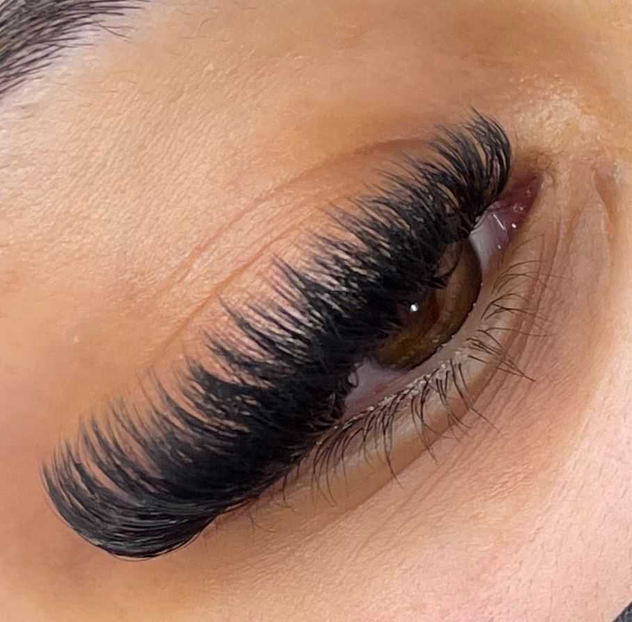 Close-up of an eye with thick, voluminous eyelash extensions.